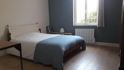 a bedroom with a large bed and a window at Fully renovated Provençal farmhouse in Châteauneuf-de-Gadagne