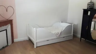 a white crib in a room with a fireplace at Fully renovated Provençal farmhouse in Châteauneuf-de-Gadagne