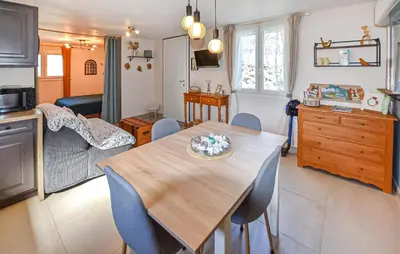 a kitchen and living room with a table and chairs at Maisonnette Avec Jacuzzi in Mazan