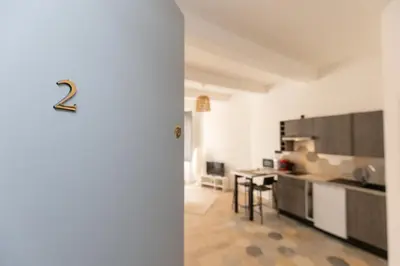 a room with a kitchen with a number two on the door at Le Rimbaud - Studio moderne en hypercentre - WiFi in Carpentras