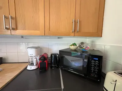 a kitchen counter with a microwave and a coffee maker at Villa des Cyprès - Charmante maison provençale - Jardin et piscine privés au cœur d un Domaine Viticole Château de Barbebelle Rognes - 10 personnes - Proche d'Aix-en Provence in Rognes