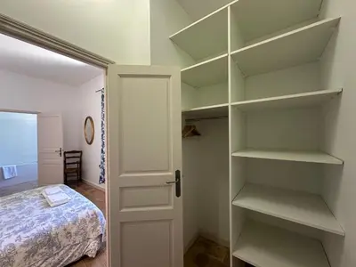 a bedroom with white shelves and a bed at Villa des Cyprès - Charmante maison provençale - Jardin et piscine privés au cœur d un Domaine Viticole Château de Barbebelle Rognes - 10 personnes - Proche d'Aix-en Provence in Rognes