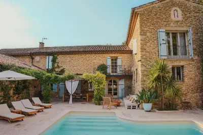 a house with a swimming pool in front of a building at Charming House At The Foot Of Luberon In Maubec in Maubec