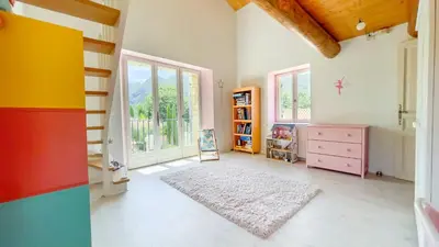a childs room with colorful furniture and a large window at Charming House At The Foot Of Luberon In Maubec in Maubec