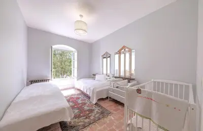 a white room with two beds and a window at Historic Mansion In Provence Vineyards in La Tour-dʼAigues
