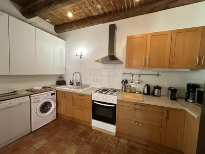 a kitchen with a stove and a dishwasher at Villa du Puits - Séjour en Provence avec piscine privée & jardin au cœur d'un domaine viticole Château de Barbebelle - Rognes - Proche d'Aix-en-Provence -10 personnes in Rognes