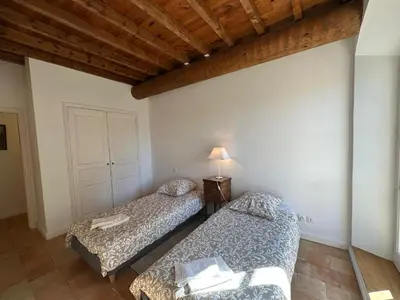 a bedroom with two beds and a lamp in it at Villa du Puits - Séjour en Provence avec piscine privée & jardin au cœur d'un domaine viticole Château de Barbebelle - Rognes - Proche d'Aix-en-Provence -10 personnes in Rognes