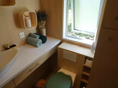 a bathroom with a toilet and a sink and a window at Tiny House avec vue sur le rocher de Saignon, Luberon in Saignon