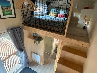 a tiny house with a bed in the middle at Tiny House avec vue sur le rocher de Saignon, Luberon in Saignon