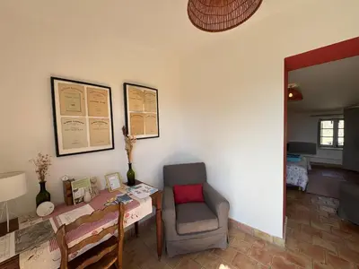 a dining room with a table and a chair at Studio Ouest - Chambre avec vue vignoble - Domaine viticole Château Barbebelle Rognes - Proche d'Aix-en-Provence in Rognes