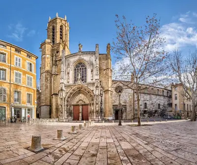 an old church with a clock tower in a courtyard at Evasion au centre d Aix loft chic et cosy in Aix-en-Provence