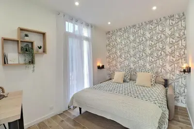 a bedroom with a bed and a wall at La Parenthèse Aixoise - 3 stars - Parking - Clim in Aix-en-Provence