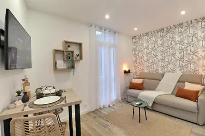 a living room with a couch and a table at La Parenthèse Aixoise - 3 stars - Parking - Clim in Aix-en-Provence
