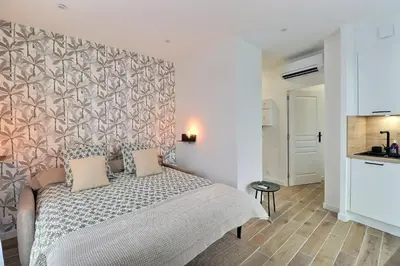 a bedroom with a bed and a wall at La Parenthèse Aixoise - 3 stars - Parking - Clim in Aix-en-Provence