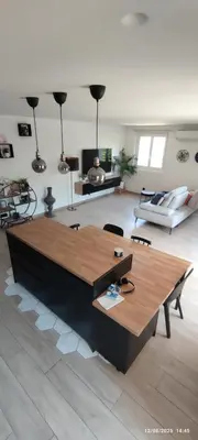 a living room with a table and a couch at Chic & Cozy 95m Apartment Perfect for Families in Aix-en-Provence