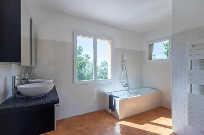 a bathroom with a tub and a sink and a bath tub at Villa sur Domaine Aix - Piscine & Tennis - Wagner in Aix-en-Provence