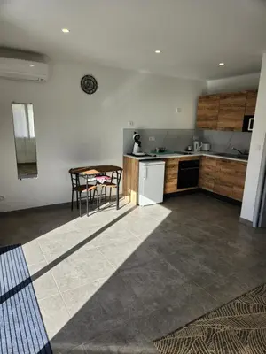 a kitchen with a table and a counter top at Tiny House T1 in Entraigues-sur-la-Sorgue