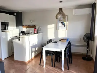 a kitchen with a white table and chairs at Appartement cosy en Provence in Mallemort