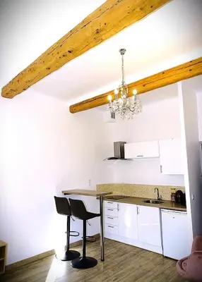 a kitchen with a dining table and a chandelier at AQUA TERRA-Studio Cozy-Aix Historic Center- SMART TV-WIFI in Aix-en-Provence