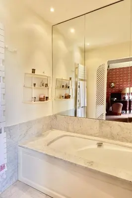a bathroom with a tub and a large mirror at Haras de Castellane in Pertuis