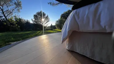 a bed sitting on top of a wooden deck at Haras de Castellane in Pertuis