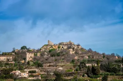 a mountain with houses on top of it at Niché au cœur de la Provence - VERNEGUES in Vernègues