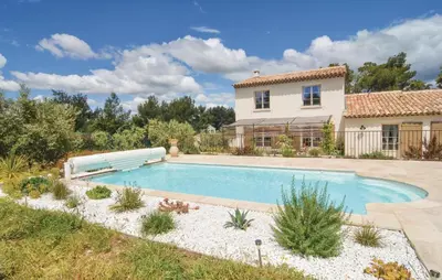 a swimming pool in front of a house at 4 Bedroom Cozy Home In Eygalières in Eygalières