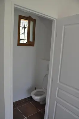 a bathroom with a toilet and a window at Domaine la Garenne in Saint-Marc-Jaumegarde