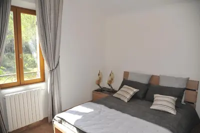 a bedroom with a bed with two pillows and a window at Domaine la Garenne in Saint-Marc-Jaumegarde