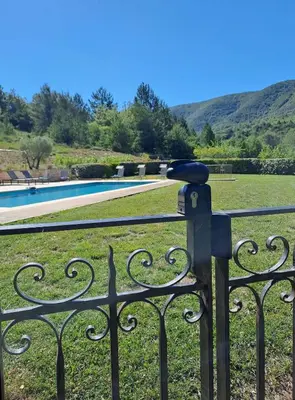 a parking meter on a fence next to a pool at Domaine de Battarel, 4 hectares en Luberon in Saint-Martin-de-Castillon