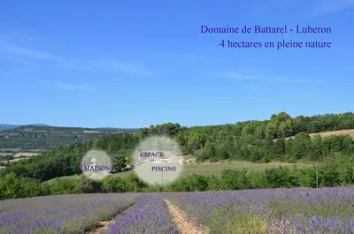 a field of lavender with a sign in the background at Domaine de Battarel, 4 hectares en Luberon in Saint-Martin-de-Castillon