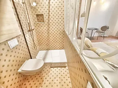 a bedroom with a large bed and a table and chairs at Le Mignet by Rentalaix in Aix-en-Provence