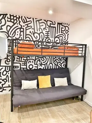 a black bunk bed with a black and white wall at La Rotonde by Rentalaix in Aix-en-Provence