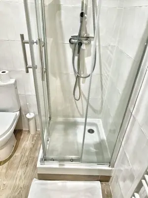 a shower with a glass door in a bathroom at La Rotonde by Rentalaix in Aix-en-Provence
