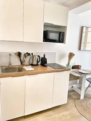 a small room with a bed and a desk with a television at La Rotonde by Rentalaix in Aix-en-Provence