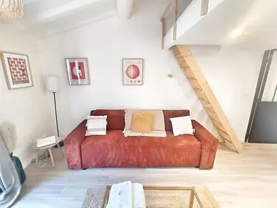 a living room with a spiral staircase in a room at Le Richelme by Rentalaix in Aix-en-Provence