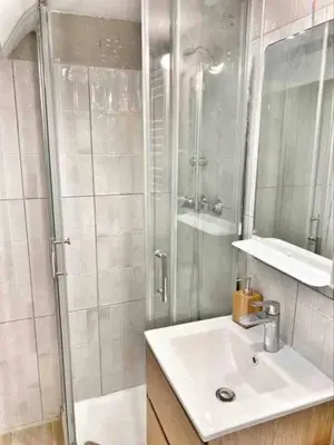 a white bathroom with a sink and a shower at Le Richelme by Rentalaix in Aix-en-Provence