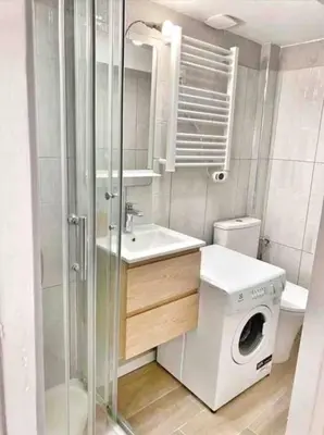a bathroom with a washing machine and a washer at Le Richelme by Rentalaix in Aix-en-Provence