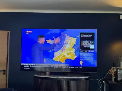 a large television screen with a man on a map at Villa Soleil Piscine Jacuzzi Pétanque Espace bbq billard et salons extérieurs in Aix-en-Provence