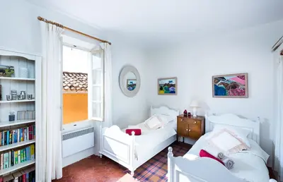 a bedroom with a bed and a book shelf at Maison Vignes in Roussillon