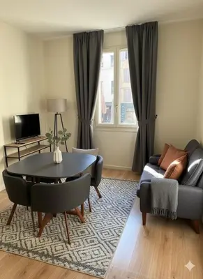 a living room with a table and a couch at Le petit cardeur in Aix-en-Provence