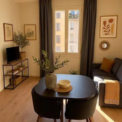 a living room with a table and a couch at Le petit cardeur in Aix-en-Provence