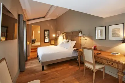 a bedroom with a bed and a desk and a desk at Domaine de Fontenille - Fontenille Collection in Lauris