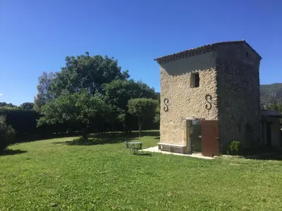 a building with the number six on it in a field at Le cabanon in Vaugines