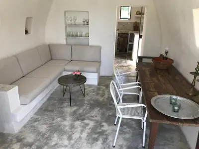 a living room with a couch and two chairs and a table at Le cabanon in Vaugines
