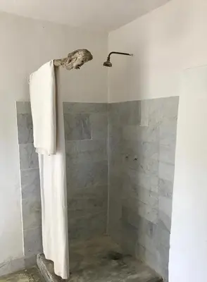 a bathroom with a shower with a towel at Le cabanon in Vaugines