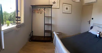 a bedroom with a bed in a room with a window at Le bois des chênes in Peypin-dʼAigues