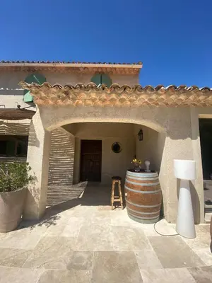 a large barrel sitting outside of a building with a door at Le bois des chênes in Peypin-dʼAigues