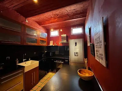 a kitchen with a large wooden bowl on the counter at Maison robion in Robion en Luberon