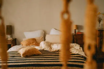 a bed with pillows on it in a bedroom at Maison Loucacia in Mormoiron